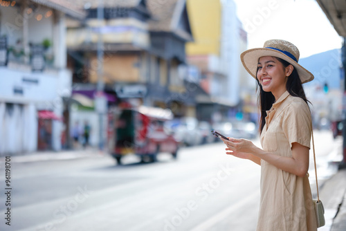 Photography A woman is standing on the street with a cell phone in her hand