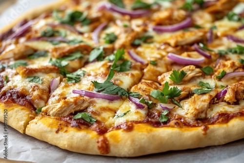 A BBQ chicken pizza topped with red onions, cilantro, and mozzarella, fresh out of the oven