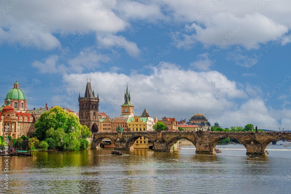 Obraz premium Beautiful cityscape image of Charles Bridge and Prague Castle with blue sky and white clouds in background, Czech Republic, Europe. Famous travel destination and touristic attraction of Czech Republic