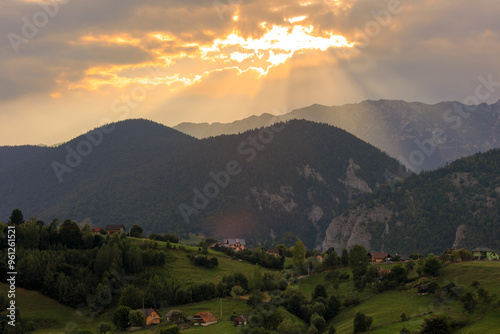 Canvas Print Golden hour summer sunset with crepuscular sun rays over the valley
