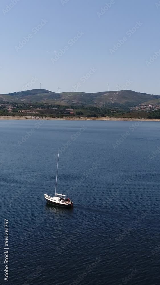 Boat in Blue Lake and Blue Sky Vertical Video Boat in Blue Lake and Blue Sky Vertical Video