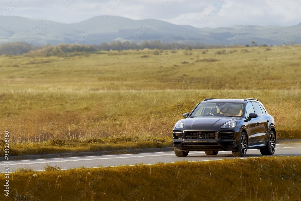 Black expensive SUV journey through countryside Black expensive SUV journey through countryside