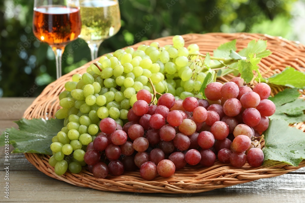 Fresh ripe grapes and glasses of wine on wooden table Fresh ripe grapes and glasses of wine on wooden table