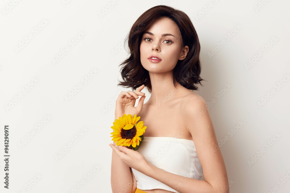 Beautiful young woman in white dress holding sunflower on white background Beautiful young woman in white dress holding sunflower on white background