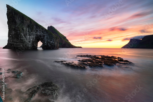 Drangarnir sea stack in the waves at sunset photo