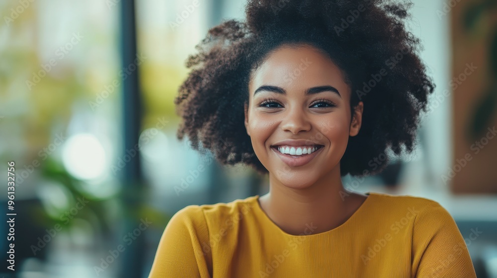 Smiling Young Woman in Yellow Sweater with Natural Hair in Bright Modern Setting Smiling Young Woman in Yellow Sweater with Natural Hair in Bright Modern Setting