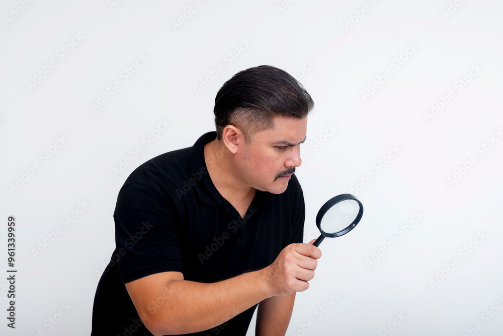 A suspicious middle-aged man inspecting something with a magnifying glass. Looking at something in detail, seemingly too good to be true. Isolated on a white background. A suspicious middle-aged man inspecting something with a magnifying glass. Looking at something in detail, seemingly too good to be true. Isolated on a white background.