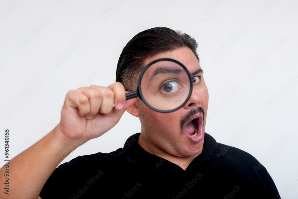A surprised middle-aged man astounded and awestruck while inspecting something with a magnifying glass. Isolated on a white background. A surprised middle-aged man astounded and awestruck while inspecting something with a magnifying glass. Isolated on a white background.