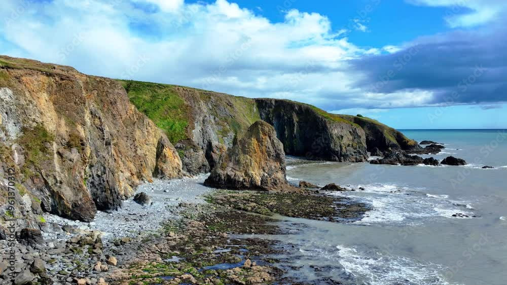 Ireland Epic coastline drone flying along cliffs with coastal erosion on The Copper Coast Drive in Waterford Ireland