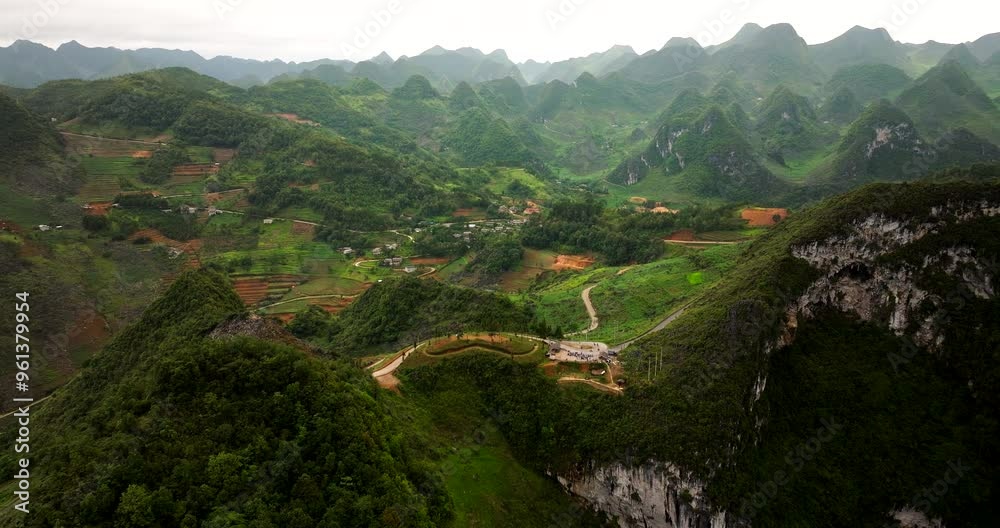 High above Ha Giang Loop’s embrace, where winding roads twist with grace High above Ha Giang Loop’s embrace, where winding roads twist with grace
