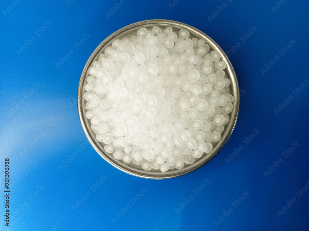 natural polymer granules, virgin raw material, virgin plastic resin, isolated on blue background, for presentation design catalog profile product plastic industrial manufacturing natural polymer granules, virgin raw material, virgin plastic resin, isolated on blue background, for presentation design catalog profile product plastic industrial manufacturing