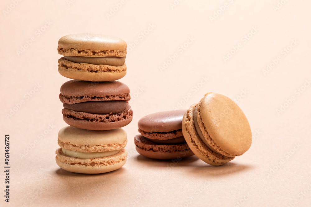 Variety of french macarons pastry on light brown background