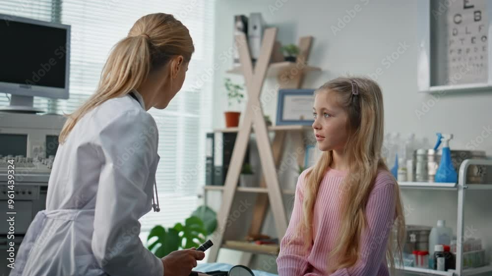 Friendly doctor talking kid in examination room. Woman pediatrician consulting Friendly doctor talking kid in examination room. Woman pediatrician consulting