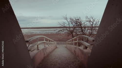 Empty concrete bridge towards a white desert.