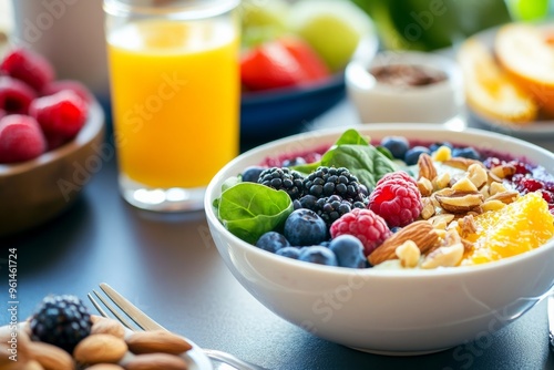 healthy nutritious breakfast bowl featuring folic acid-rich foods, such as a smoothie bowl topped with spinach, berries, and nuts. glass of orange juice for added vitamin C