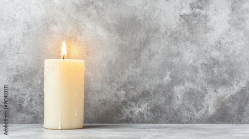 Burning Candle on Grey Concrete Background