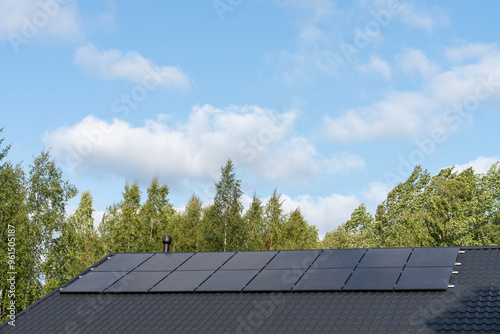 Solar panels on the roof of a house on a sunny summer day, Northern Finland