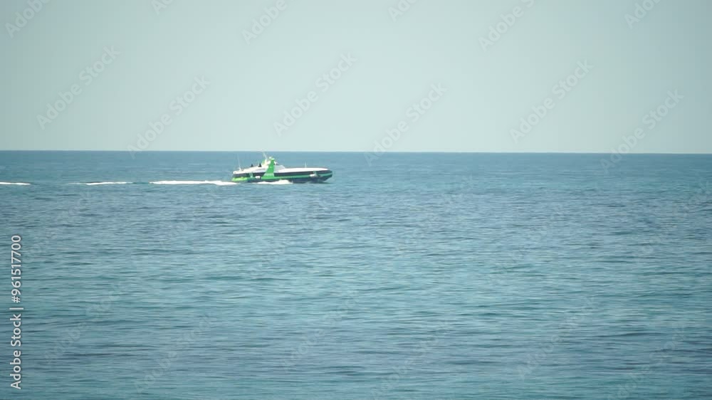 A Green and White Boat on a Blue Ocean A Green and White Boat on a Blue Ocean