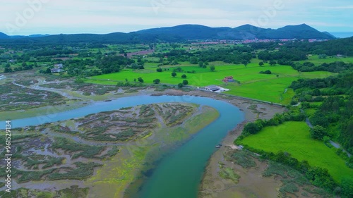 Aerial drone view of the marshes at low tide at sunset in Escalante in the Marismas de Santoña, Victoria y Joyel Natural Park. Cantabrian Sea. Santoña, Cantabria, Spain, Europe photo