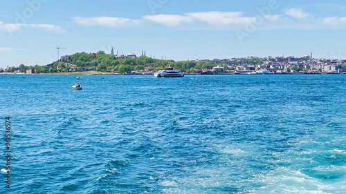 Istanbul city from sea. Wave trail from speed travel boat on blue sea. 4K video clip