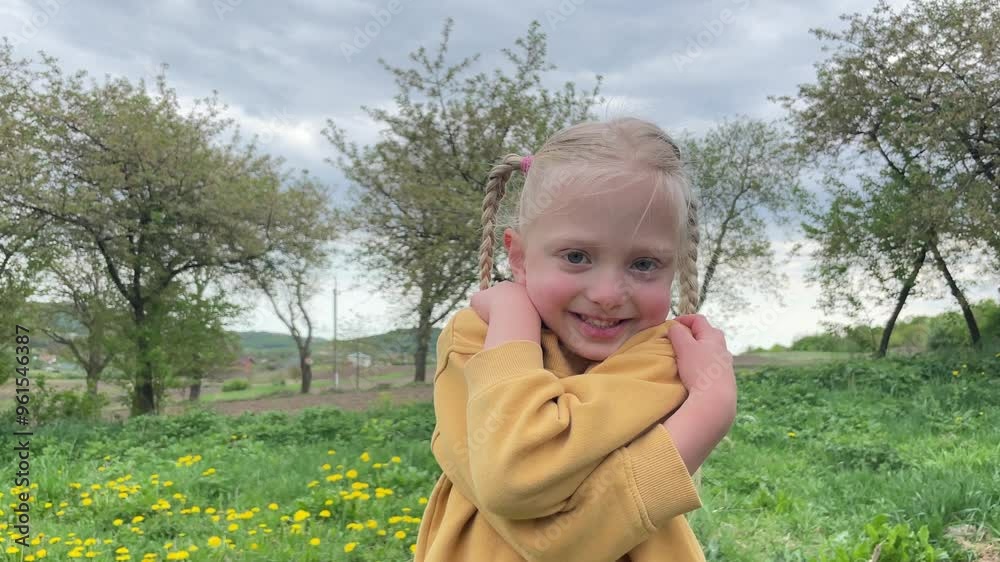 Happy smiling girl with blonde hair is posing in a field Happy smiling girl with blonde hair is posing in a field