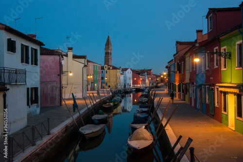  A night view of a canal and of colored houses in the island of Burano, Venice, Italy.