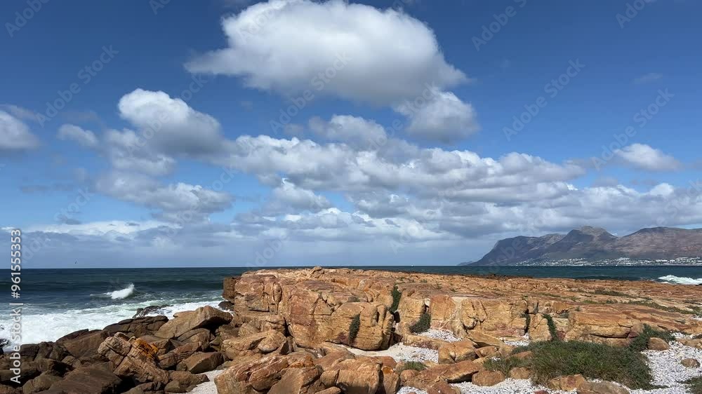 Waves smashing against massive boulders along the rocky coastline Waves smashing against massive boulders along the rocky coastline