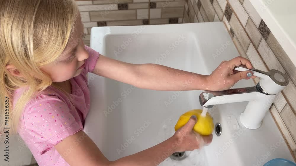Young girl washes a lemon under running water in a bright white kitchen sink, promoting cleanliness and healthy habits Young girl washes a lemon under running water in a bright white kitchen sink, promoting cleanliness and healthy habits