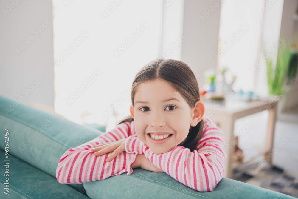 Photo portrait of young smiling toothy funny kid little brunette girl staying at home spending summer holidays isolated in her room Photo portrait of young smiling toothy funny kid little brunette girl staying at home spending summer holidays isolated in her room