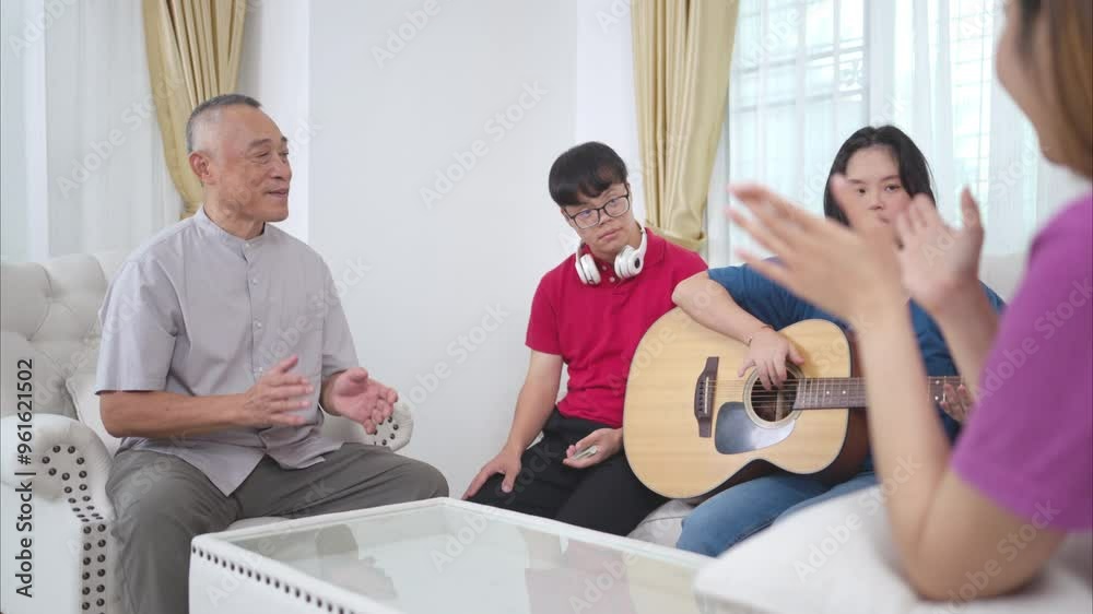 A grandfather with grandchild enjoys singing and dancing together at home during the holidays A grandfather with grandchild enjoys singing and dancing together at home during the holidays