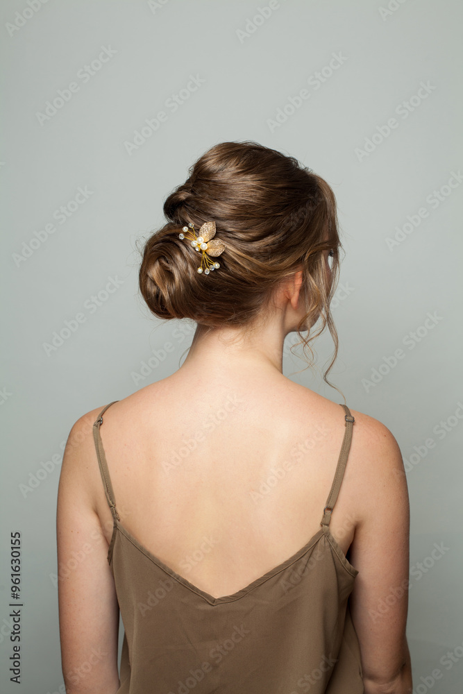 Rear view of female hairstyle middle bun with brown hair. Rear view of female hairstyle middle bun with brown hair.