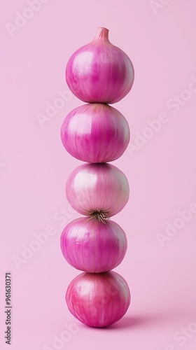 A stack of red onion balancing to top with solid bacground