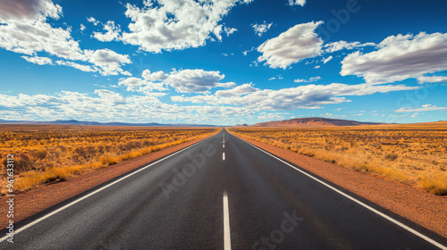 Scenic road through the outback in Australia, with vast open landscapes.