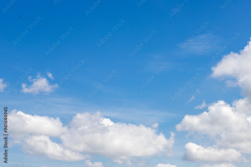 Serene White Clouds Floating in Clear Blue Sky Serene White Clouds Floating in Clear Blue Sky