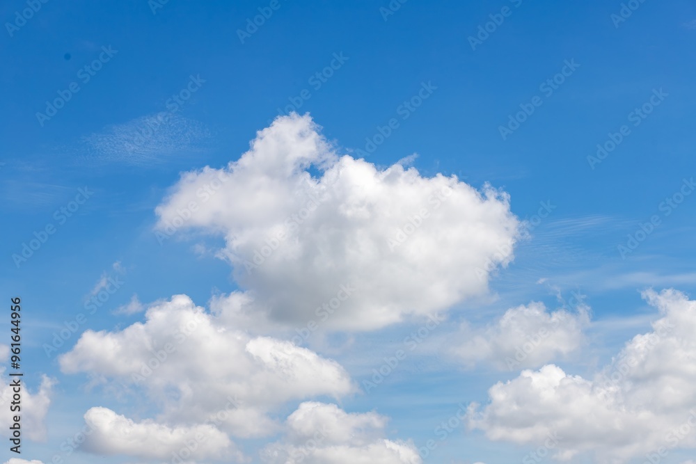 Fluffy White Clouds in Bright Blue Sky Daytime Scene