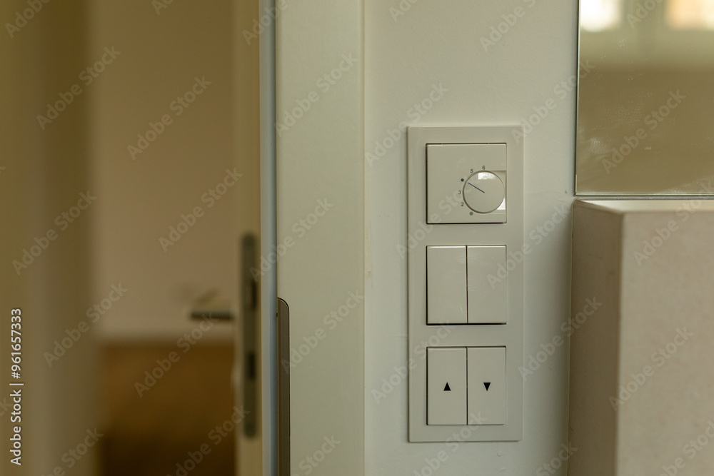 Simple white switches and a thermostat on a wall Minimalist design Simple white switches and a thermostat on a wall Minimalist design