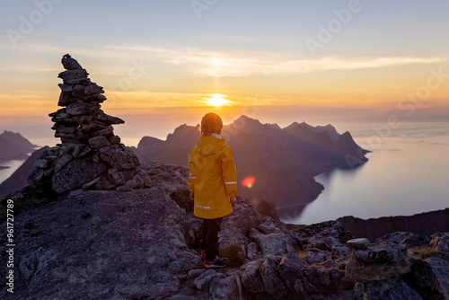 Children and adults, family with dog, hiking Grytetippen trail in Senja, Lofoten on a sunny summer day photo