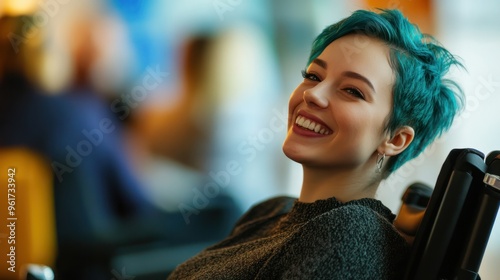 Inclusive image of happy female with blue hair, sitting in a wheelchair attending a conference photo