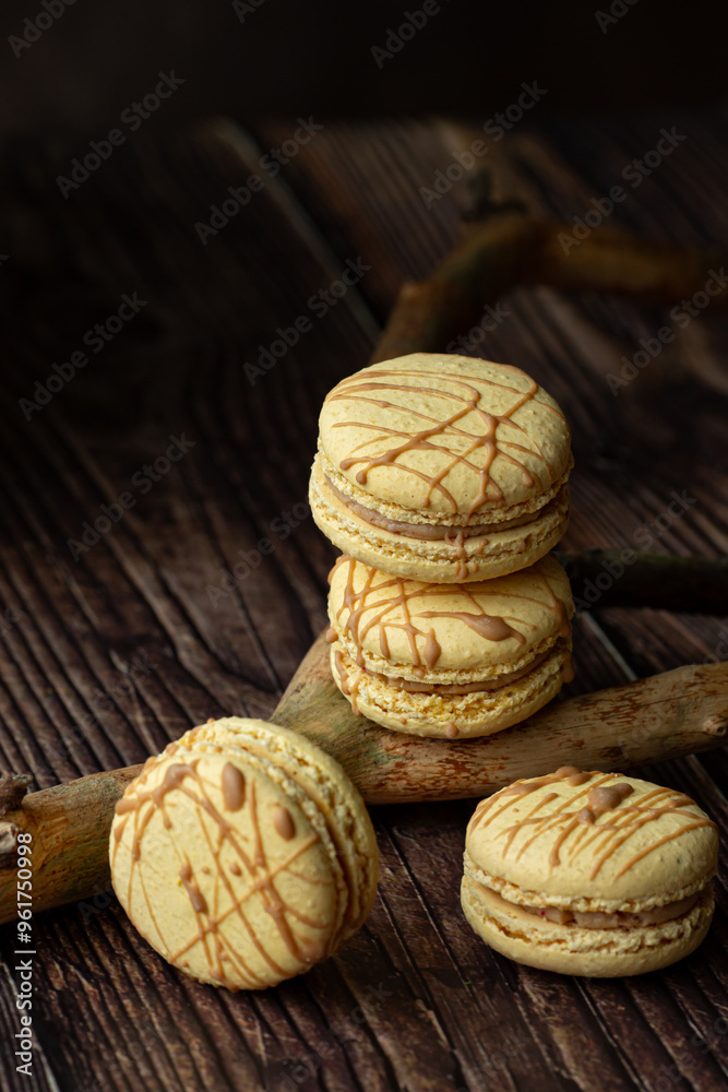 Light brown, beige french macaroons on dark brown background Light brown, beige french macaroons on dark brown background