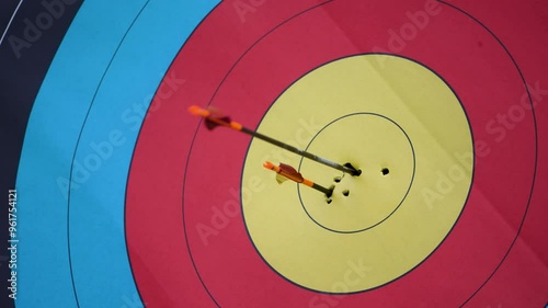 Close up arrows hit target center with olympic archery sport arrows