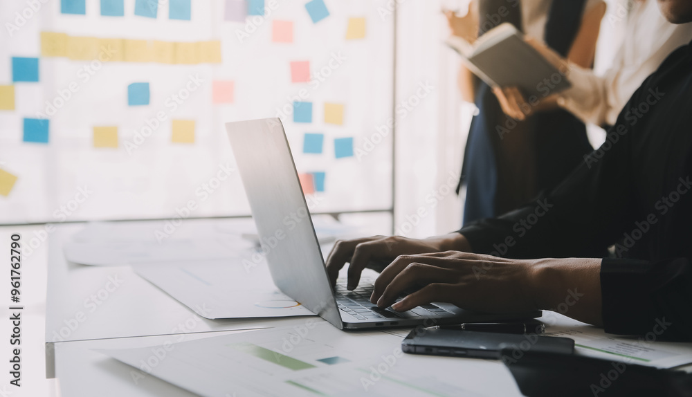 Fototapeta premium Financial analysts analyze business financial reports on a digital tablet planning investment project during a discussion at a meeting of corporate showing the results of their successful teamwork.