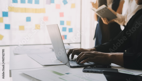 Financial analysts analyze business financial reports on a digital tablet planning investment project during a discussion at a meeting of corporate showing the results of their successful teamwork.
