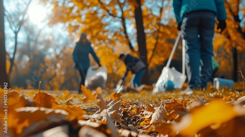 Obraz na płótnie Volunteers actively participating in a park cleanup during autumn, gathering trash in bags surrounded by vibrant orange and yellow leaves. The image highlights community engagement and environmental w salonie