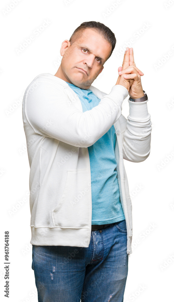 Middle age arab man wearing sweatshirt over isolated background Holding symbolic gun with hand gesture, playing killing shooting weapons, angry face Middle age arab man wearing sweatshirt over isolated background Holding symbolic gun with hand gesture, playing killing shooting weapons, angry face