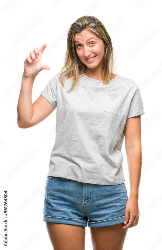 Young beautiful woman over isolated background smiling and confident gesturing with hand doing size sign with fingers while looking and the camera. Measure concept. Young beautiful woman over isolated background smiling and confident gesturing with hand doing size sign with fingers while looking and the camera. Measure concept.