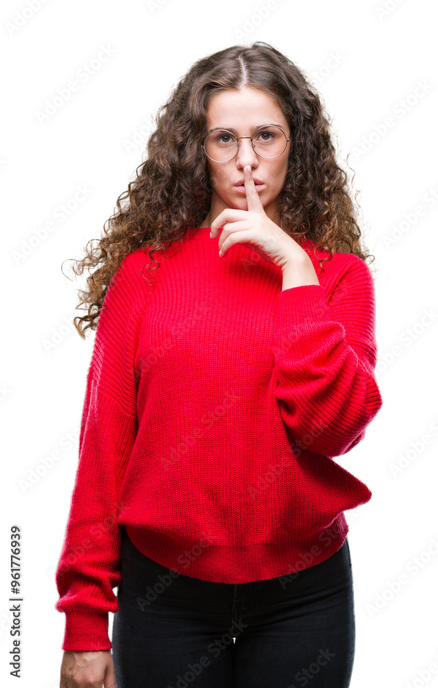 Beautiful brunette curly hair young girl wearing glasses and winter sweater over isolated background asking to be quiet with finger on lips. Silence and secret concept. Beautiful brunette curly hair young girl wearing glasses and winter sweater over isolated background asking to be quiet with finger on lips. Silence and secret concept.