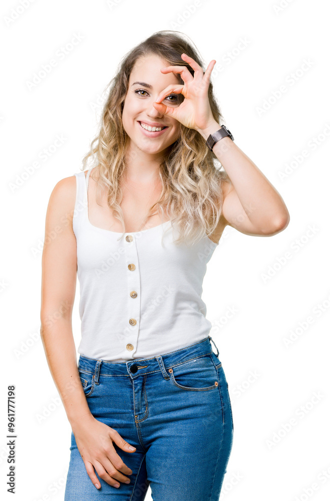 Young beautiful blonde woman over isolated background doing ok gesture with hand smiling, eye looking through fingers with happy face. Young beautiful blonde woman over isolated background doing ok gesture with hand smiling, eye looking through fingers with happy face.