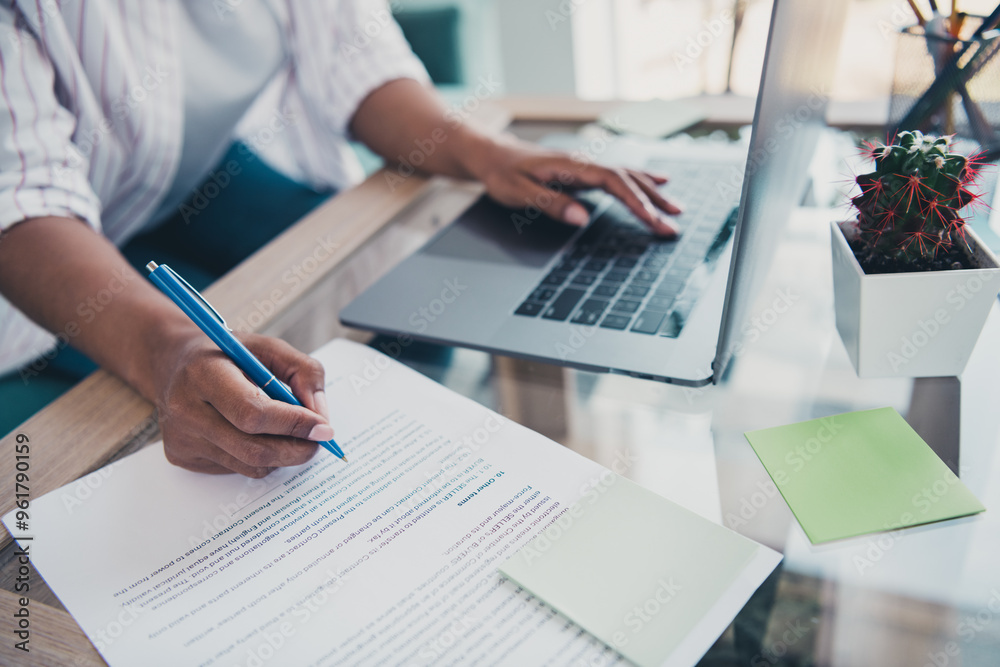 Cropped portrait of young woman arm hold pen use laptop wear shirt modern interior flat indoors Cropped portrait of young woman arm hold pen use laptop wear shirt modern interior flat indoors