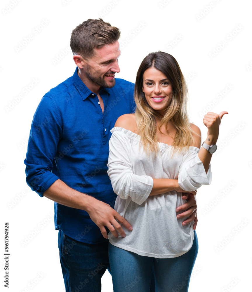 Young couple in love over isolated background smiling with happy face looking and pointing to the side with thumb up. Young couple in love over isolated background smiling with happy face looking and pointing to the side with thumb up.