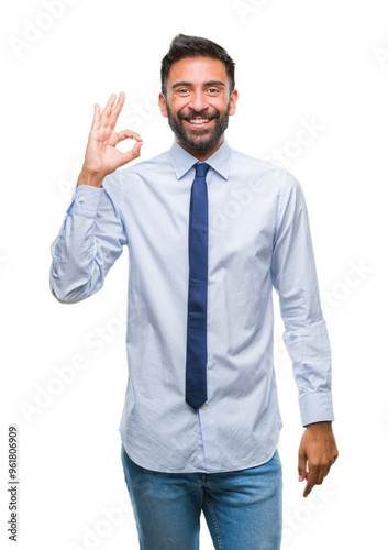 Adult hispanic business man over isolated background smiling positive doing ok sign with hand and fingers. Successful expression.